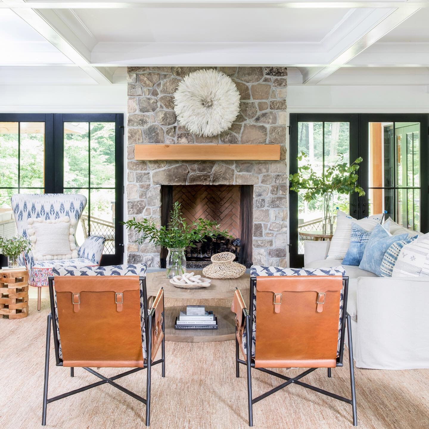 Stone fireplace, leather chairs, and reclaimed wood are just a few of the elements we used to create a warm and cozy family room. Pretty soon the autumn leaves will be showing off and creating an amazing view for this family. Can&rsquo;t wait  Inte